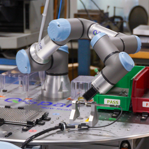 A UR Collaborative robot in a machine shop measuring a drill